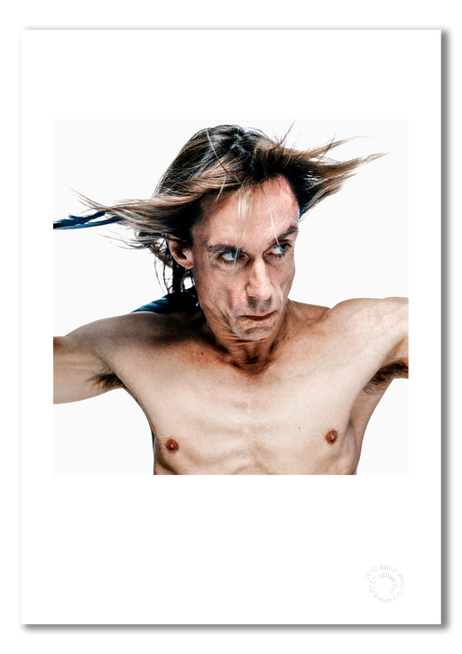 Colour close-up of Iggy Pop by Gavin Evans, 1996. Bare-chested with black feathers against white background. A3 giclée print with white border, Iggy Pop Collection.