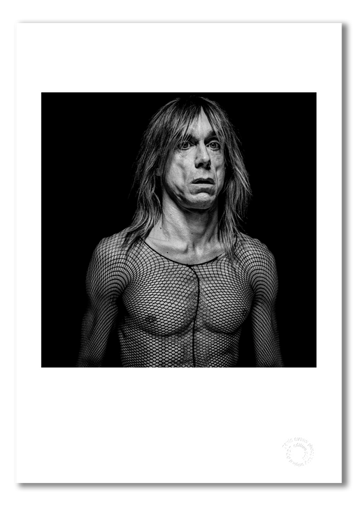 Black and white portrait of Iggy Pop by Gavin Evans, 1996. Wearing fishnet top, introspective. A3 giclée print with white border, Iggy Pop Collection.