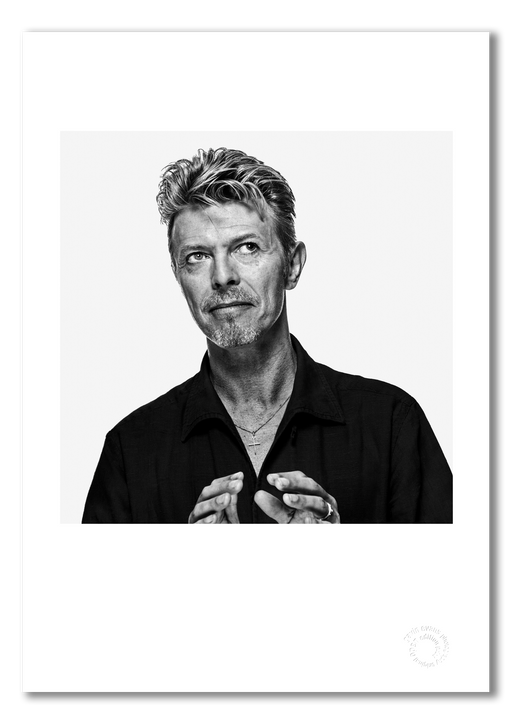 Black and white off-camera portrait of David Bowie by Gavin Evans, 1995. Graphic gaze, A3 giclée print with white border, Bowie Collection.