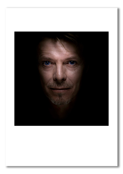Colour portrait of David Bowie by Gavin Evans, 1995. Sapphire blue contact lenses, serene expression. A3 giclée print with white border, Bowie Collection.