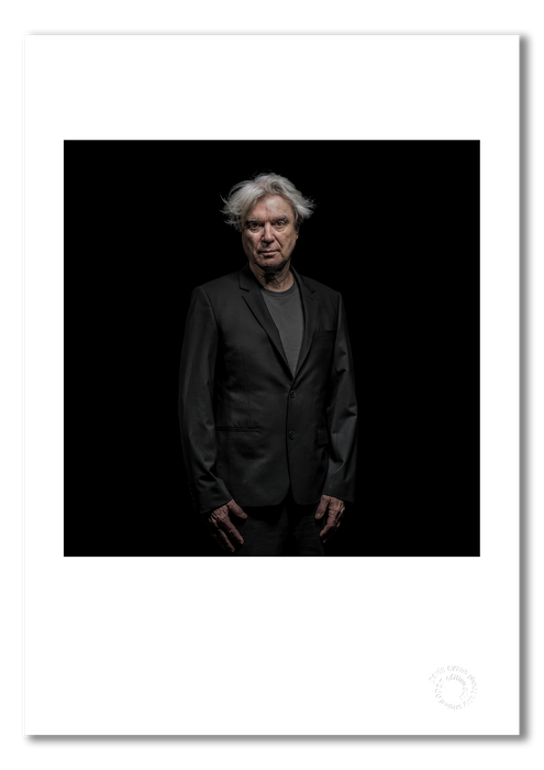 A3 open edition fine art print of David Byrne with a white border, printed on semi-matt archival cotton paper. This 2018 colour studio portrait was taken in Berlin by Gavin Evans and is embossed for authenticity.