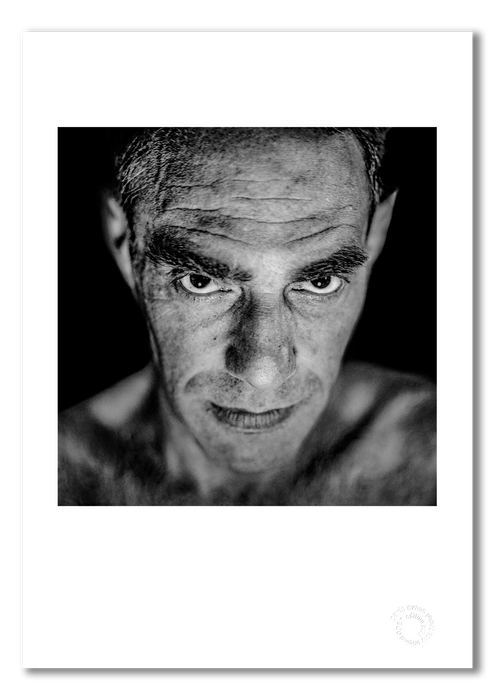 A3 fine art print of Derek Jarman featuring a white border, printed on semi-matt archival cotton paper. This 1993 studio portrait, taken in Edinburgh by Gavin Evans, captures the artist with disarming intimacy. Embossed for authenticity.