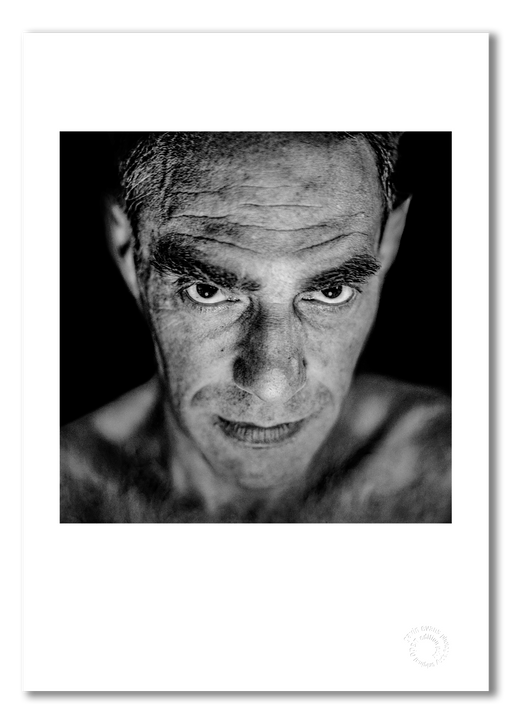 A3 fine art print of Derek Jarman featuring a white border, printed on semi-matt archival cotton paper. This 1993 studio portrait, taken in Edinburgh by Gavin Evans, captures the artist with disarming intimacy. Embossed for authenticity.