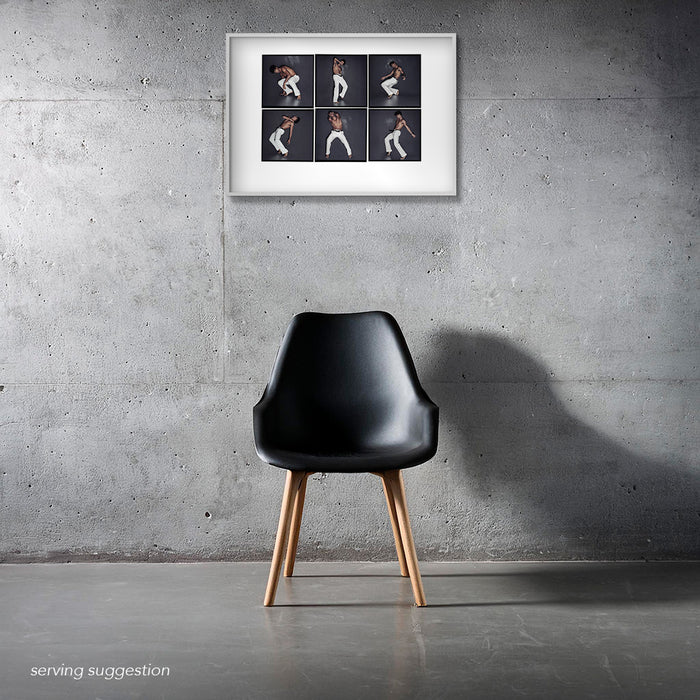 ramed A2 Lightbox portrait of Carlos Acosta by Gavin Evans. Six dancing frames displayed in a monochrome interior, The Lightbox Collection.