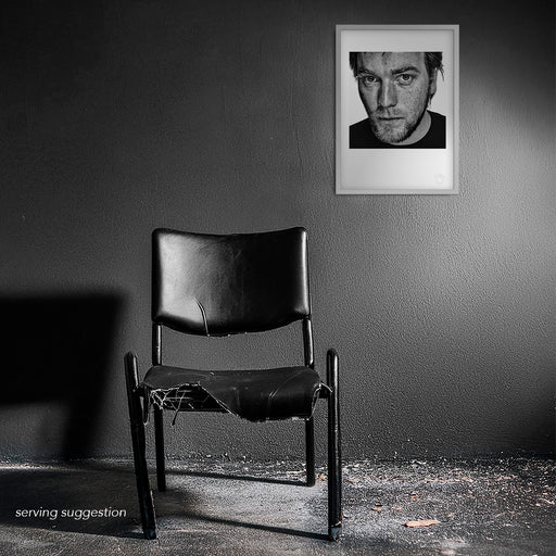 Black and white A3 print of Ewan McGregor by Gavin Evans, 1999. Wistful close-up studio portrait, Icons Collection. Displayed framed in a distressed room setting for visual context.