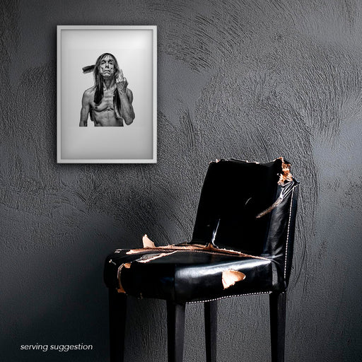 Framed B&W image of Iggy Pop by Gavin Evans, 1996. Iconic defiant pose, finger raised, feathers, Iggy Pop Collection.