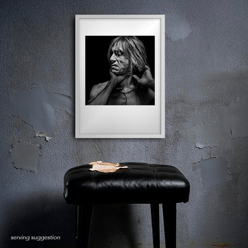 Framed B&W portrait of Iggy Pop by Gavin Evans, 1996. Twisted posture in dramatic black and white, displayed in gritty setting, Iggy Pop Collection.