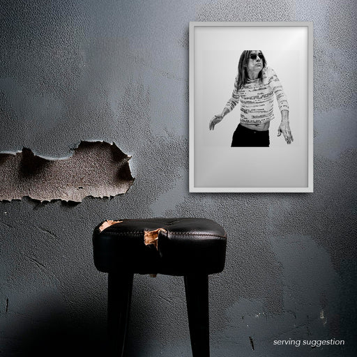 Framed B&W Iggy Pop portrait by Gavin Evans, 1996. Wearing profanity-print shirt, displayed in dilapidated room, Iggy Pop Collection.