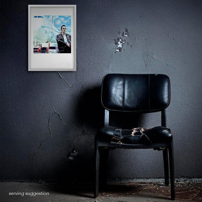 Framed Joe Strummer portrait by Gavin Evans, 1988. Iconic Clash image displayed in distressed interior, Icons Collection.