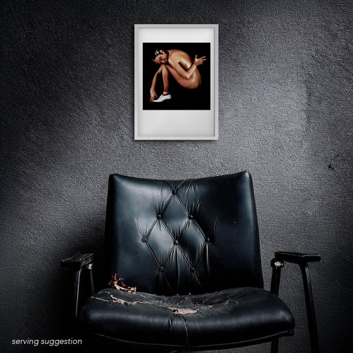 A3 colour portrait of John Galliano by Gavin Evans, 1991. Nude against black background, sensual and provocative, Icons Collection. Displayed framed in a distressed room setting for visual context.