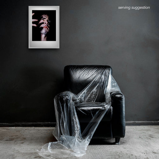 Framed colour semi-profile of Nick Cave by Gavin Evans. Fingers cast shadows across face. Displayed in monochrome room, Nick Cave Collection.