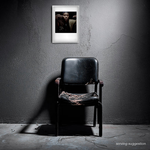 Framed version of the RZA #2 A3 fine art print displayed in a weathered interior. The portrait’s mood and minimalism contrast strikingly with the textured backdrop, enhancing its meditative power.