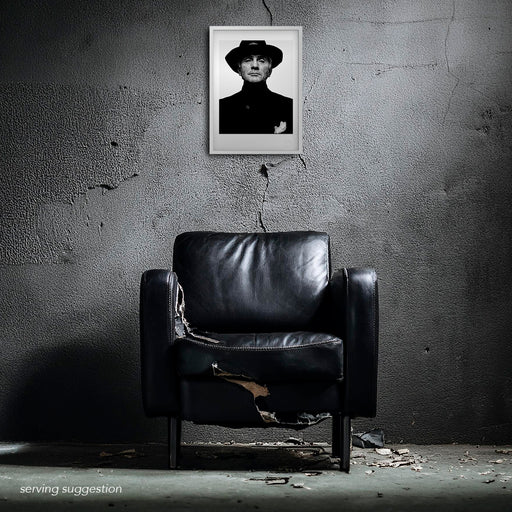 A styled room shot showing the Terence Stamp A3 print framed within a distressed space. The raw interior enhances the mystique of the monochrome 1992 portrait by Gavin Evans, highlighting its quiet cinematic power.