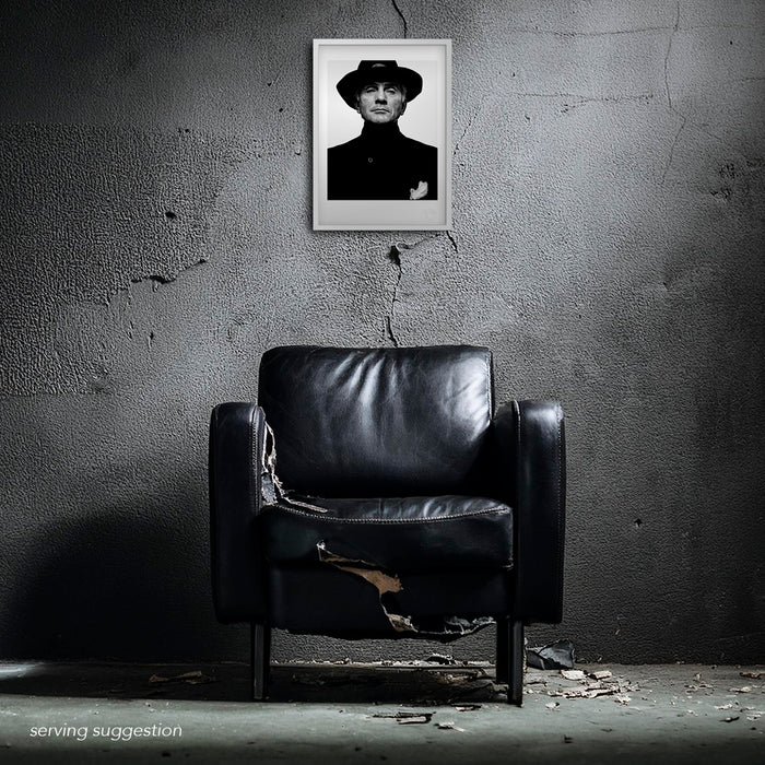 A styled room shot showing the Terence Stamp A3 print framed within a distressed space. The raw interior enhances the mystique of the monochrome 1992 portrait by Gavin Evans, highlighting its quiet cinematic power.