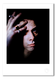 Nick Cave #5, direct gaze, lit cigarette, colour, black background, Bayswater London 1989, by Gavin Evans — fine art photography print