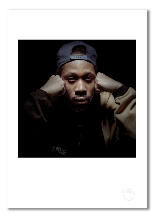 A3 open edition giclée print of RZA presented with a white border, printed on semi-matt archival cotton paper. Photographed in 1997 by Gavin Evans, this close-up studio portrait captures RZA’s intensity and iconic presence. Embossed for authenticity