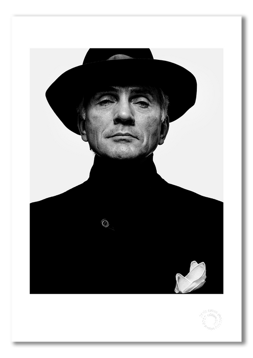 A3 giclée print featuring Terence Stamp, photographed in 1992 by Gavin Evans. This striking black and white portrait is professionally printed on semi-matt archival cotton paper and marked with an embossed stamp for authenticity.
