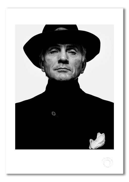 A3 giclée print featuring Terence Stamp, photographed in 1992 by Gavin Evans. This striking black and white portrait is professionally printed on semi-matt archival cotton paper and marked with an embossed stamp for authenticity.